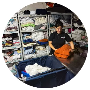 A team member sorting donated goods onto shelves